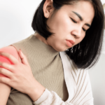 Woman suffering with a frozen shoulder